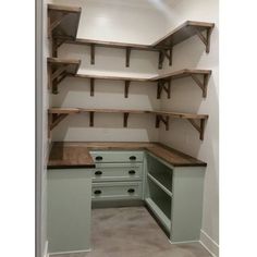 an empty walk in closet with shelves and drawers