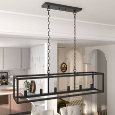 a dining room and kitchen area with white chairs, black chandelier and wooden table