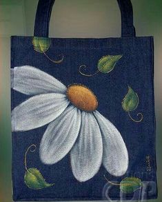 a blue bag with white flowers painted on it