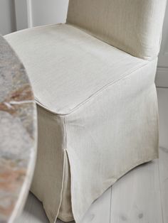 a close up of a chair with a table in the background