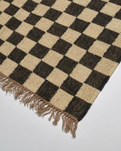 a black and white checkered rug with fringes