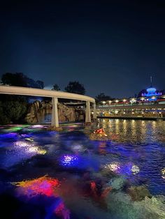 the lights are on in the water by the bridge