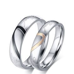 two wedding rings with the word love engraved on each side and gold in between them