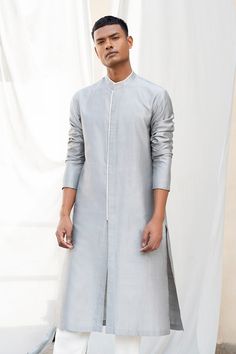 Grey kurta with contrast hem detail and side slits. 
Components:1
Neckline:Mandarin
Sleeve Length:Three quarter
Fabric:Cotton Silk
Color:Grey
Note: Pant worn by the model is not for sale - Aza Fashions Kurta Poses, Silk Kurta For Men, Muslim Men Clothing, Fancy Suits, Silk Kurtas, Stylish Boy Clothes, Shalwar Kameez Designs, Men's Closet, Boys Kurta Design