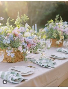 the table is set with flowers and place settings for an outdoor dinner or brunch