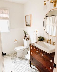 the bathroom is decorated in white and gold