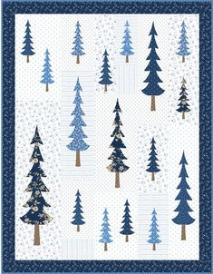 a blue and white quilted christmas tree pattern with gold foil on the trees in the snow