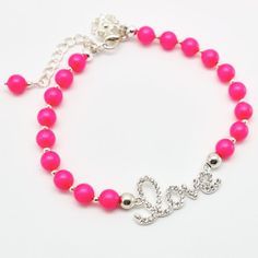 Neon Pink Pearl funny bracelet.This bracelet look beautiful and you can wear with almost anything.This bracelet made of:...Clear rhinestone LOVE Sign......round Pink Swarovski Pearls(6 mm)......silver plated trigger clasp and flower charm...This bracelet measures about 7 1/2" ,extender chain is 1 3/4" long.All metal components are silver plated.This bracelet is  packaging in an elegant organza pouch ready for gift giving.............................Thank you for visit.Martaky Adjustable Pink Chain Bracelet Gift, Pink Rhinestone Beaded Bracelet As Gift, Valentine's Day Adjustable Bracelets With Rhinestones, Cheap Nickel-free Pink Bracelets, Valentine's Day Adjustable Rhinestone Bracelets, Trendy Pink Adjustable-length Bracelet, Playful Pink Nickel-free Bracelets, Neon Pink Bracelet, Hot Pink Bracelets