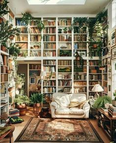 a living room filled with lots of plants and bookshelves full of books on shelves