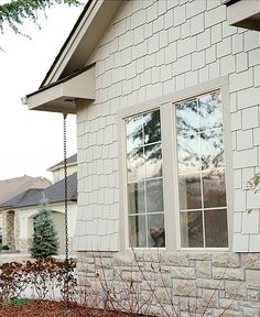 a white brick house with two windows