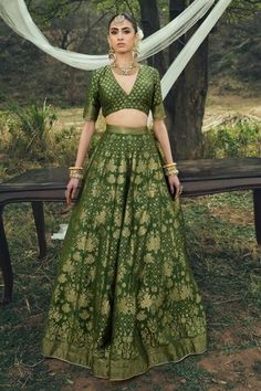 Forest green vegan silk lehenga with an attached cancan and floral weaving pattern. Comes with a padded blouse and a dupatta. - Aza Fashions Green Banarasi Silk Party Sets, Green Meenakari Sharara, Fitted Green Banarasi Silk Dress, Fitted Green Raw Silk Lehenga, Elegant Green Meenakari Lehenga, Elegant Green Lehenga With Meenakari, Green Brocade Sharara With Resham Embroidery, Green Brocade Sharara For Eid, Elegant Green Banarasi Silk Choli