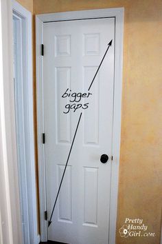 a white door with an arrow drawn on the front and side of it that says bigger goals