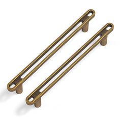 two antique brass cabinet pulls on a white background