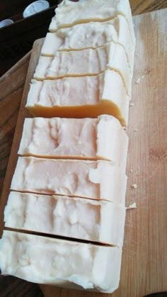 slices of bread sitting on top of a wooden cutting board