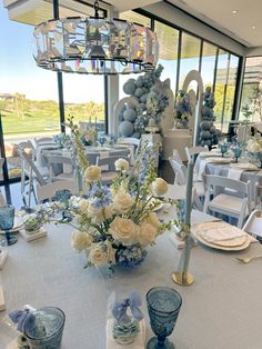 a table set up with blue and white decorations