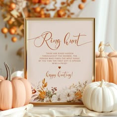 a wedding sign with pumpkins and other decorations on the table in front of it