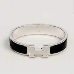 Brand New. Available In White And Black. Narrow Bracelet In Black Enamel Silver Bracelet Featuring The Initial Letter H And A Clic - Lock Closure. Circumference: 6" .47" Wide Disclosure: This Is A Generic Bracelet. I’m In No Way Shape Or Form Advertising This As Any Specific Brand, Company Name Or Trademark. Hermes Clic H Bracelet, H Bracelet, Hermes Bracelet, Hermes Jewelry, Hermes Accessories, Black Bracelets, Jewelry Inspo, Silver Enamel, Bracelet Silver