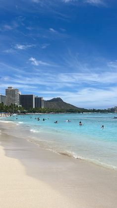 people are swimming in the ocean on a sunny day at waiki'i beach