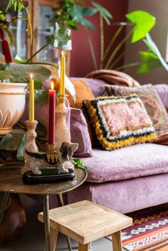 a living room filled with furniture and lots of plants