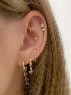 a close up of a person wearing ear piercings