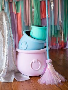 there are many bowls stacked on top of each other in this room with ribbons hanging from the ceiling