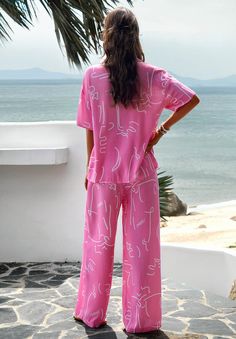 Get ready for some fun in the sun with our Beach Vacation Matching Set! This pink set includes everything you need for a stylish and coordinated beach look. No need to stress about packing, we've got you covered. Soak up the sun and turn heads with this must-have set! Size Guide: Model is 5’6” tall, and has a 33.2” bust, 26.4” waist, & 35.2” hips. She is wearing a S / US 4 / AU 8. This matching set is true to size. Material: 100% Viscose. Feature: Collared. Tropical print. Breathable Fabrication. Front button closures. Wide leg pants. Relaxed fit. (1 pcs top + 1 pcs pants, 2 pcs in total) Care Instructions: Machine wash / Cold hand wash Pink Summer Loungewear Set, Beachwear Short Sleeve Set For Day Out, Playful Summer Sets For Poolside, Beachwear Set With Short Sleeves For Day Out, Short Sleeve Beach Sets For Summer, Casual Pink Swimwear For Vacation, Summer Day Out Sets With Short Sleeves, Summer Day Out Set With Short Sleeves, Summer Day Out Sets