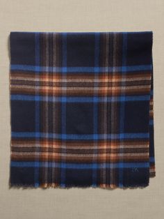 A cool-weather classic, this timeless plaid scarf is crafted from an exceptionally warm and rich wool to keep you cozy all season long.  Length: 76" (103. 5cm) Width: 17" (43cm) Classic Scarves For Cold Weather In Fall, Classic Scarves For Fall And Cold Weather, Classic Blue Scarf For Fall, Classic Plaid Scarves For Fall, Classic Wool Scarves For Fall, Casual Wool Plaid Scarves, Casual Plaid Wool Scarf, Classic Plaid Scarves For Winter, Wool Plaid