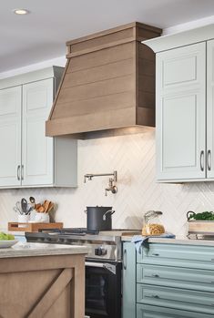 a kitchen with blue cabinets and an oven