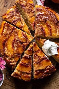 a pie with slices cut out on a cutting board next to flowers and a bowl of whipped cream