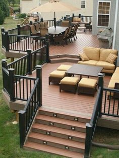 an outdoor deck with seating and umbrellas