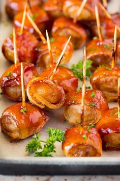 small appetizers with toothpicks and ketchup on a tray