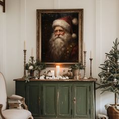 a living room decorated for christmas with a painting on the wall and candles in front of it