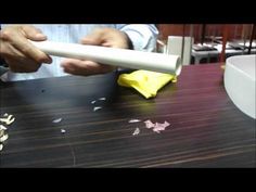 a person cutting paper with a knife on a table