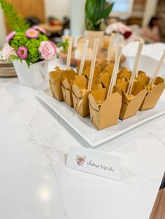 there are many small trays on the table with food in them that is ready to be eaten