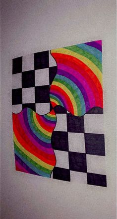 two pieces of paper that have been cut out to look like rainbows and checkered squares