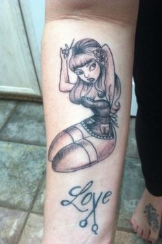 a woman's leg with a tattoo on it that reads, love and scissors