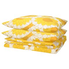 three yellow and white flowered pillows stacked on top of each other in front of a white background