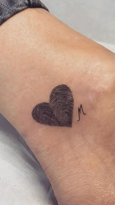 a fingerprint in the shape of a heart is shown on a woman's foot