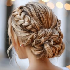 a woman with braids in her hair is looking down at the ground and lights behind her