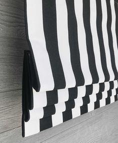 black and white striped curtains hanging on the wall