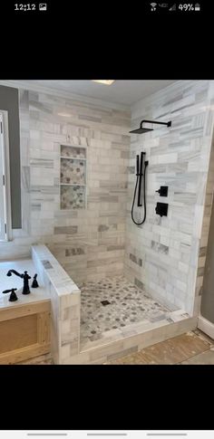 a bathroom with a walk in shower next to a sink and bathtub under a window