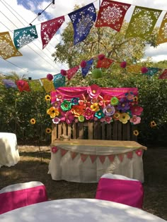 colorful paper flowers decorate an outdoor table