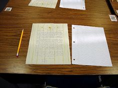 several pieces of lined paper on a wooden table