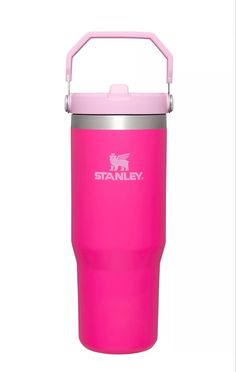 the stanley stainless steel insulated tumbler is pink and has a metal lid with an insulated handle