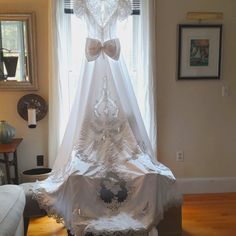 a white wedding dress on display in front of a window