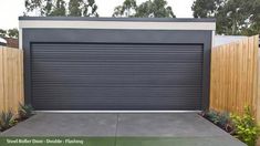 a garage door is closed in front of a fence