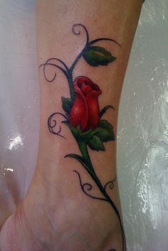 a foot with a rose tattoo on it