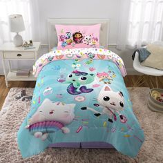 a child's bed with an animal themed comforter