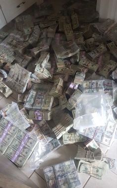 a pile of money sitting on top of a kitchen floor