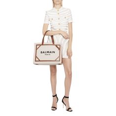 Balmain "B Army" tote bag in cotton, linen, and calf leather  Flat shoulder straps  Open top with hook closure; side snap closures  Interior, one flap pouch and one card slot  Approx. 16.5"H x 13.3"W x 5.9"D Spot clean Made in Italy Luxury White Canvas Bag With Top Carry Handle, White Luxury Canvas Shopping Bag, Luxury White Canvas Shopping Bag, Designer Canvas Bag With Detachable Handle, Luxury Canvas Bag With Detachable Handle For Shopping, Designer Bags With Gold-tone Hardware For Summer, Designer Summer Bags With Gold-tone Hardware, Summer Designer Bags With Gold-tone Hardware, Luxury Cream Bag For Summer